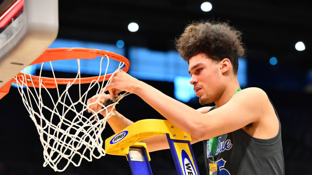 Lutheran East's Jesse McCulloch cuts down the nets after the winning the 2023 OHSAA Division III state championship
